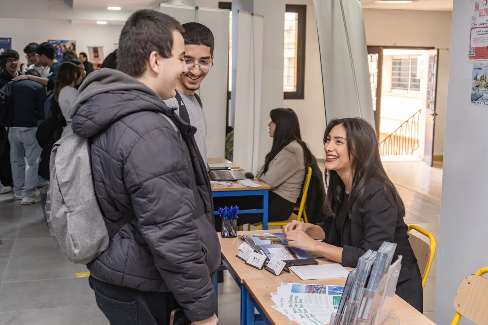 TISC advisor talking with students at a student fair